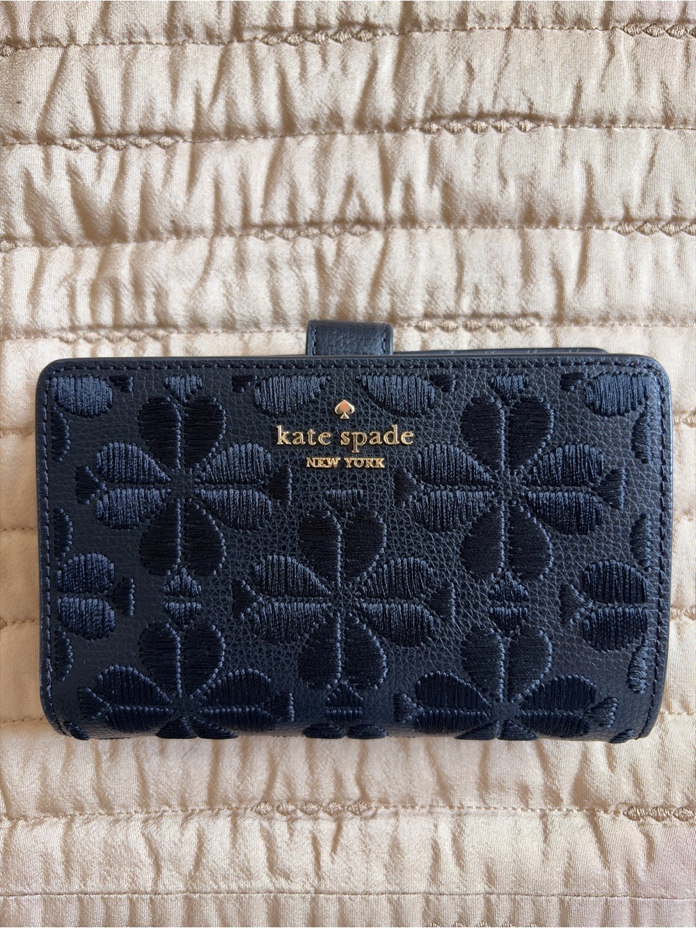 kate spade navy floral-embossed continental wallet with gold logo